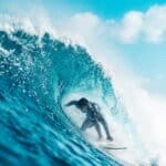 Unrecognizable energetic surfer riding azure sea wave