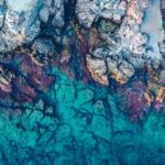 Aerial Photography of Rocks Beside Body of Water