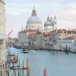 View of grand canal and old cathedral of Santa Maria della Salute in Venice in Italy on early calm morning