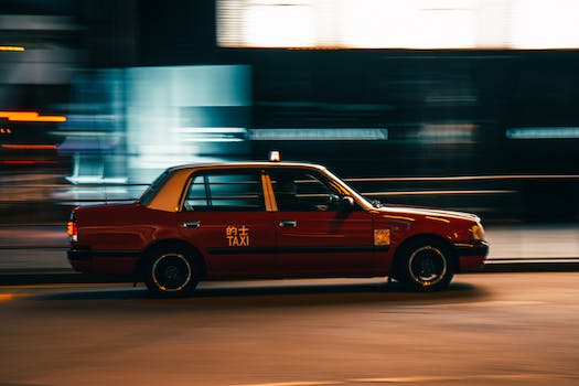 Vintage taxi car driving on street at night