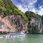 People on Ship Traveling on Water Beside Land